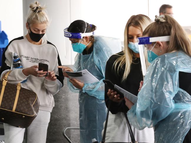 (Mia Giuliani and Matilda Bredon are checked by COVID staff on arrival) People arrive from Sydney to arrive at Melbourne Airport as many flights are cancelled with the latest COVID outbreak in SydneyÃs Northern beaches. Monday, December 21, 2020. Picture: David Crosling