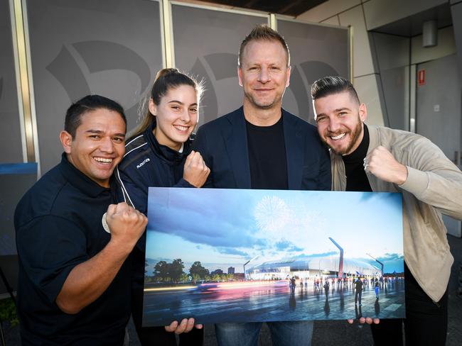 Former Socceroo Vince Grella, centre, with the design of the proposed Dandenong Stadium.