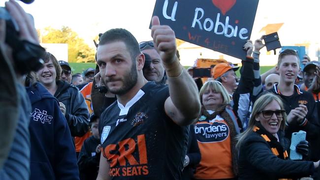 Robbie Farah being mobbed by fans.