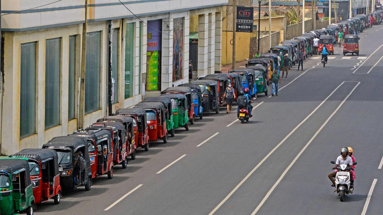Autorickshaw drivers queue along a street to buy gasoline from a fuel station in Colombo as a severe shortage wreaks havoc. Picture: AFP