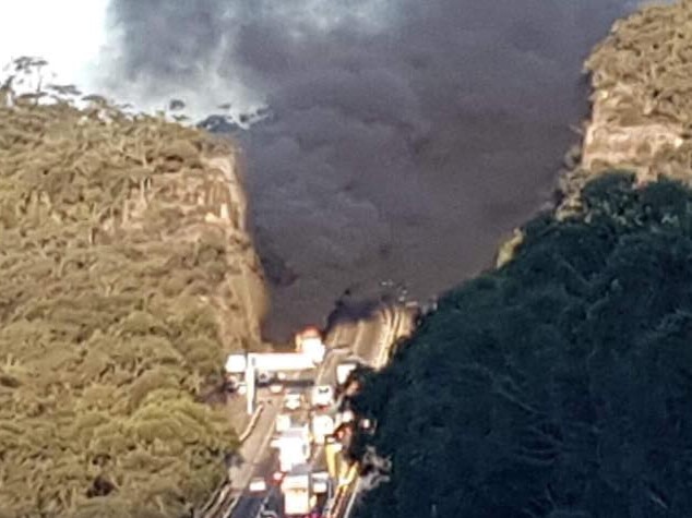 Smoke billows over the accident scene where two people died. Picture: NSW Rural Fire Service