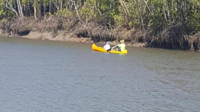 Two men paddle off on a small canoe and head into croc-infested waters.