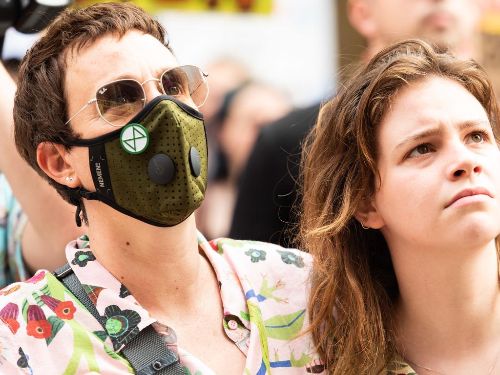 Two woman are pictured at a climate action rally in Sydney, on Friday, January 10, 2019. (AAP Image/Michael Bilbe-Taylor)