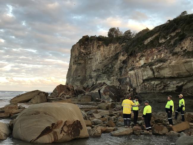 Council staff at the base of Terrigal Skillion where tonnes or rock collapsed yesterday. Picture: Cathy Stubbs.