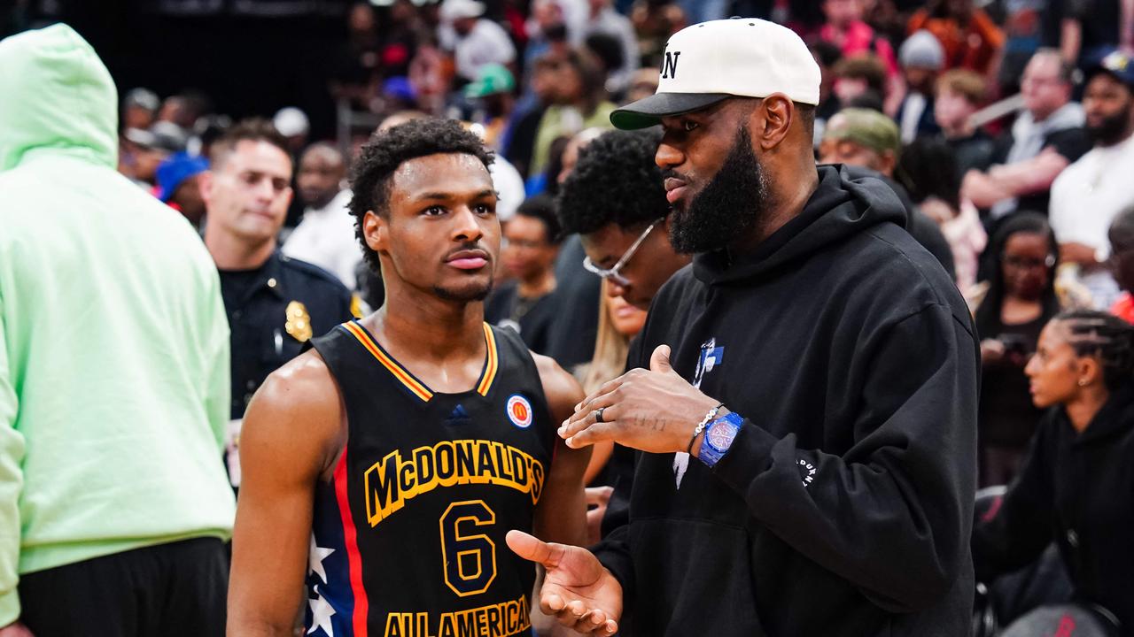 (FILES) Bronny James #6 of the West team talks to Lebron James of the Los Angeles Lakers after the 2023 McDonald's High School Boys All-American Game at Toyota Center on March 28, 2023 in Houston, Texas. Bronny James, the 19-year-old son of Los Angeles Lakers superstar LeBron James, was selected 55th overall by the Los Angeles Lakers in June 27's second round of the NBA Draft. Four-time NBA Most Valuable Player LeBron James, the 39-year-old Lakers playmaker who is a four-time NBA champion, has said he would like to play alongside his son next season -- in what would be the first father-son combination in NBA history. (Photo by Alex Bierens de Haan / GETTY IMAGES NORTH AMERICA / AFP)