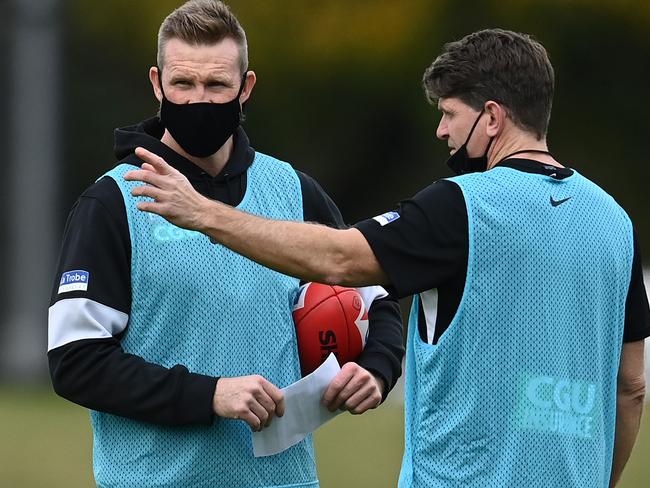 MELBOURNE, AUSTRALIA - JUNE 01: Magpies head coach Nathan Buckley talks to assistant coach Robert Harvey during a Collingwood Magpies AFL training session at Holden Centre on June 01, 2021 in Melbourne, Australia. (Photo by Quinn Rooney/Getty Images)