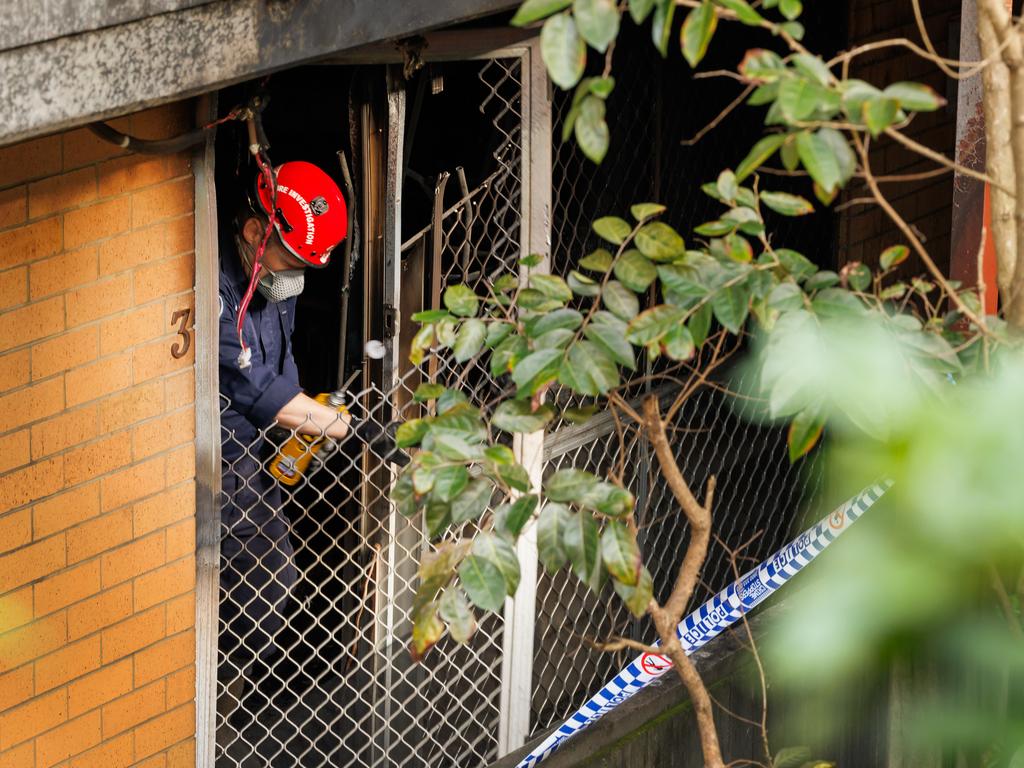 An investigator at the scene of the unit fire on Sunday. Picture: Lachie Millard