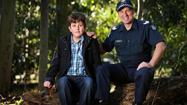 Luke Shambrook, 11, with Sgt Greg Paul. Victoria Police has nominated Luke for a Pride of Australia Child of Courage Award. Picture: Mark Stewart