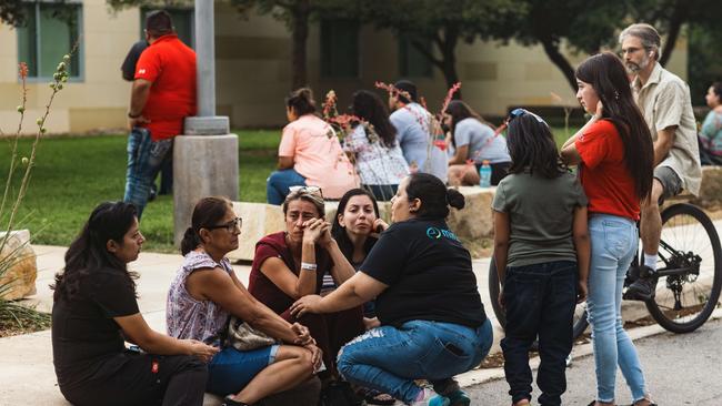 People seen grieving near the primary school in Uvalde, Texas. Picture: Jordan Vonderhaar/ Getty Images/AFP