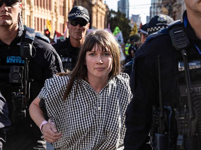 MELBOURNE, AUSTRALIA - NCA NewsWire Photos - 16 MARCH 2024: Extinction Rebellion activists get arrested by members of Victoria Police as they blocked the Flinders Street Station intersection Picture: NCA NewsWire / Diego Fedele