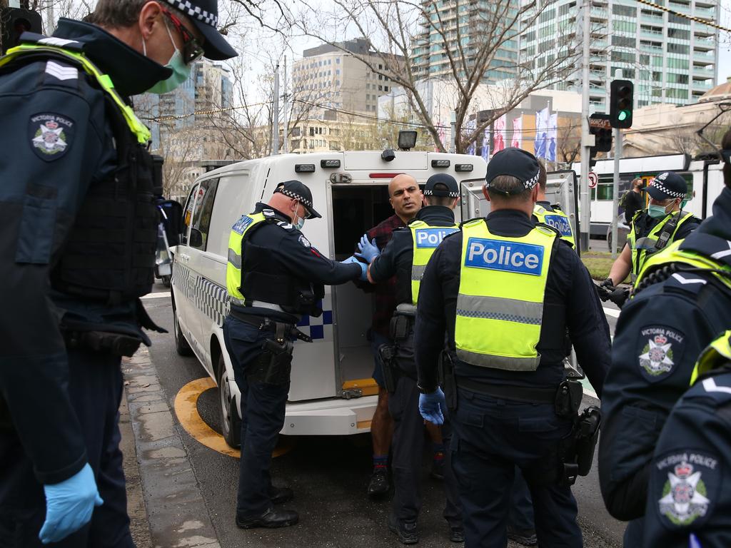 Police pictured making arrests at freedom protests in Melbourne on Saturday.