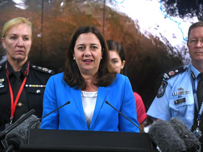 The Fire (left) and Police Commissioner (right) are consigned to the sidelines as Premier Annastacia Palaszczuk briefs the state on the recent Cyclone Owen. Picture: John Gass/AAP