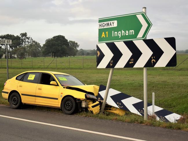 The wreck of a bright yellow Hyandai hatchback car pictured  on the Bruce Highway on Sunday morning after it collided with a traffic sign south of Ingham on Friday evening. Picture: Cameron Bates