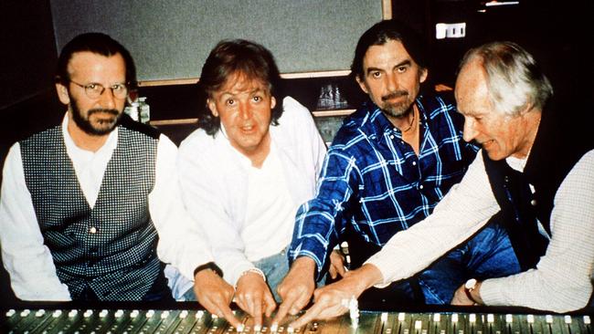 Members of Beatles rock band: Ringo Starr, Paul McCartney and George Harrison with record producer George Martin.