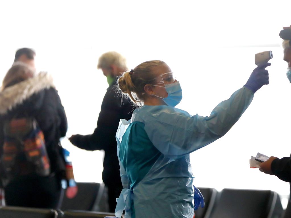 Jetstar passengers get health checks at after disembarking a plane from Melbourne. Picture by Damian Shaw