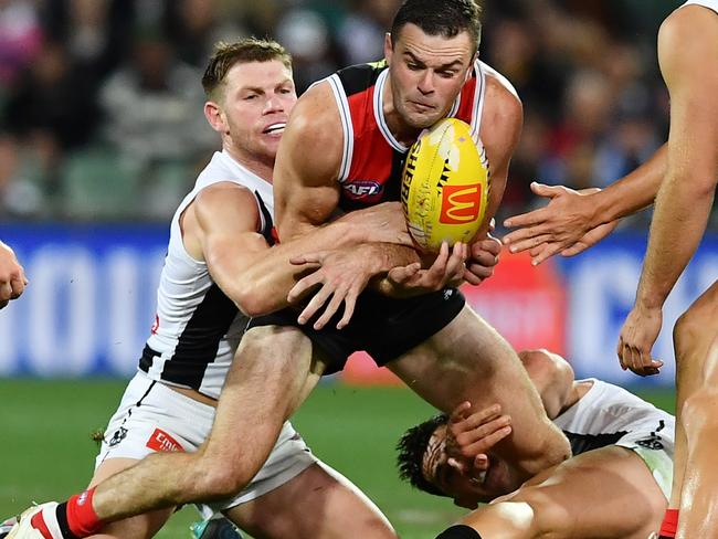 ADELAIDE, AUSTRALIA - APRIL 16: Brad Crouch of the Saints tackled by Taylor Adams  and Brayden Maynard of the Magpies during the round five AFL match between St Kilda Saints and Collingwood Magpies at Adelaide Oval, on April 16, 2023, in Adelaide, Australia. (Photo by Mark Brake/Getty Images)