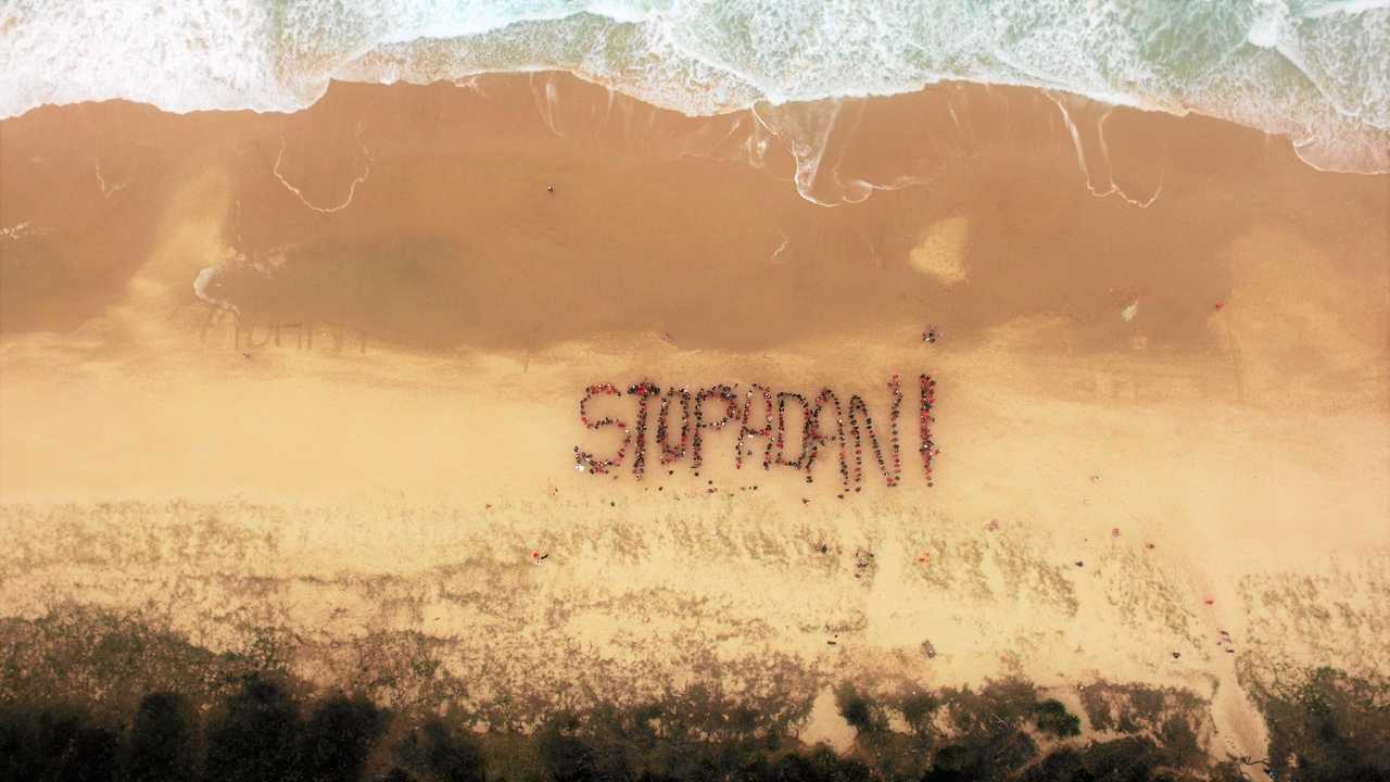 Protesters against plans for Adani's coal mine in Central Queensland make their feelings clear on Peregian Beach. Picture: Eamon Kriz/ In The Air