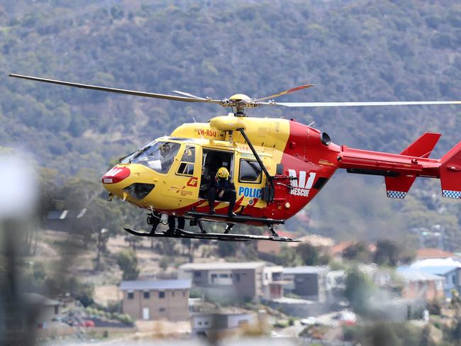 The Westpac Rescue helicopter flying overhead at the command post for the search for missing Tasmanian man Elson Kiddle. Picture: LUKE BOWDEN