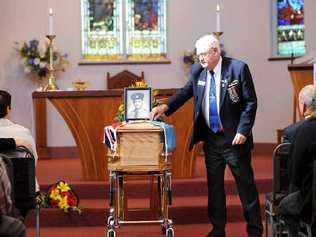 CHAMPION BLOKE: Max Lewis, president of the Ballina RSL Sub-branch, places a red poppy on the coffin of Stan Tilley during yesterday’s funeral service at St Mary’s Anglican Church in Ballina. Picture: Jacklyn Wagner