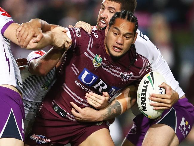 Martin Taupau of the Sea Eagles is tackled by Storm defence during the Round 18 NRL match between the Manly-Warringah Sea Eagles and the Melbourne Storm at Lottoland in Sydney, Saturday, July 14, 2018. (AAP Image/Brendon Thorne) NO ARCHIVING, EDITORIAL USE ONLY