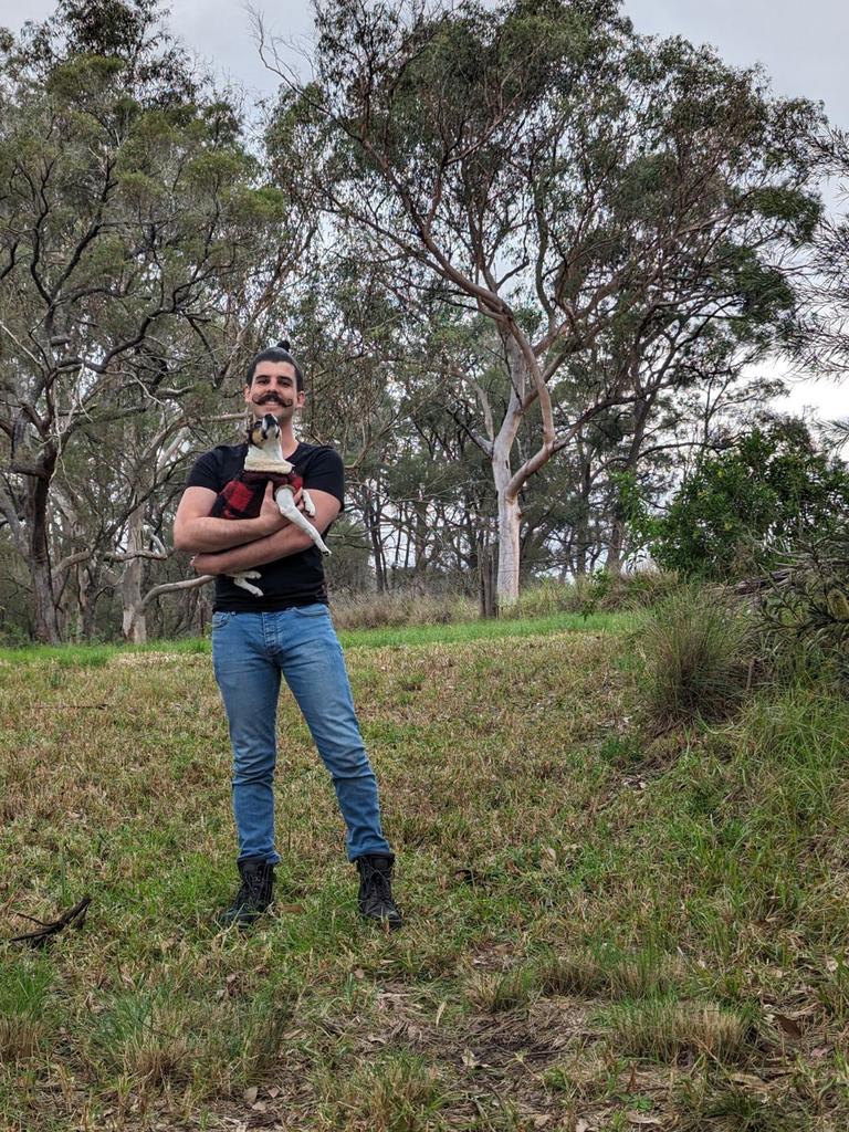 Chris Galea with his dog, standing on the land where his Tiny Mobile home will soon be located.