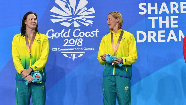 Silver medalist Cate Campbell of Australia (left) and her sister gold medalist Bronte Campbell (right) of Australia are seen during the medal ceremony for the Womens 100m Freestyle Final on day five of swimming competition at the XXI Commonwealth Games at Gold Coast Aquatic Centre on the Gold Coast, Australia, Monday, April 9, 2018. (AAP Image/Darren England) NO ARCHIVIING, EDITORIAL USE ONLY