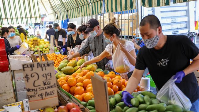 Lockdown shoppers buying essential fruit at a grocery store in Cabramatta, in Sydney’s southwest on Sunday. Picture: Stephen Cooper