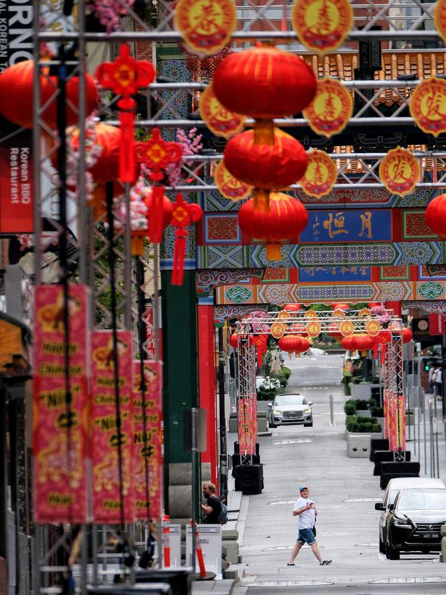 A food delivery driver rides his bike along Melbourne's Chinatown as the state is under a five day lockdown to stop the spread of COVID-19. Picture: Luis Ascui