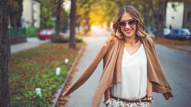 A young fashionable girl walking through the city and posing. Picture: freemixer