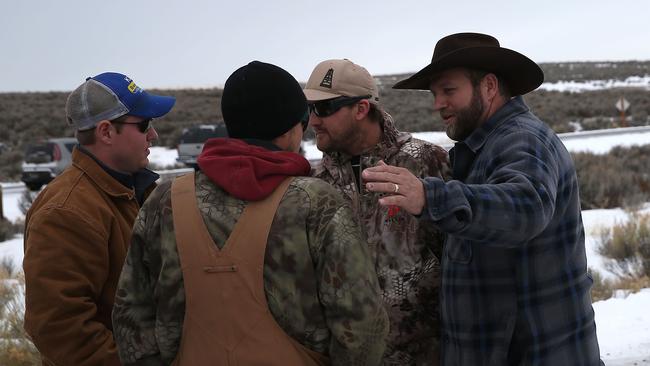 United stand ... Ammon Bundy, (right) the leader of the anti-government militia with members of his security team in front of the Malheur National Wildlife Refuge Headquarters.
