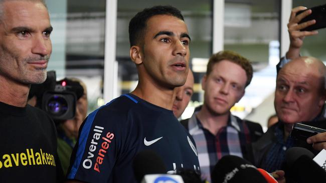 Footballer Hakeem al-Araibi speaks to the media beside ex-Socceroos captain Craig Foster upon his arrival at the airport in Melbourne. Picture: AFP