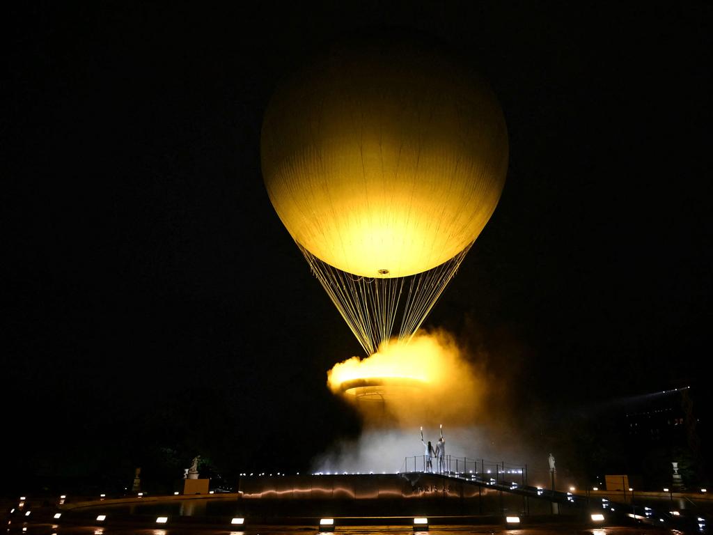 Torchbearers, French former sprinter Marie-Jose Perec and French judoka Teddy Riner, stand as the cauldron, with the Olympic flame lit, lifts off while attached to a balloon during the opening ceremony of the Paris 2024 Olympic Games, at the Jardin des Tuileries (Tuileries Garden), in Paris, on July 26, 2024. Picture: AFP