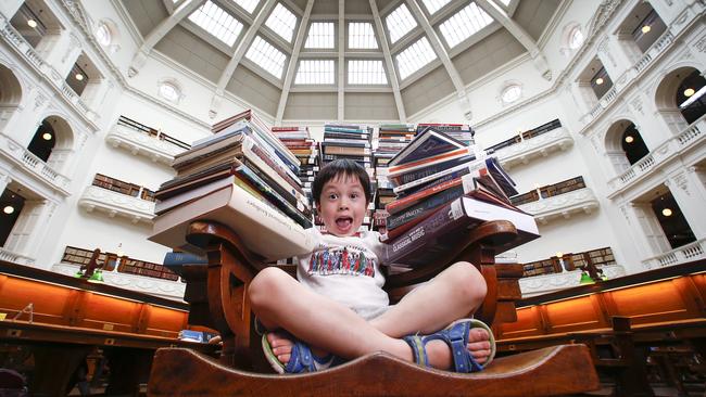 State Library regular Isaac 4 getting in some serious reading with 165 books from the shelves of the Dome Reading Room. Picture: David Caird