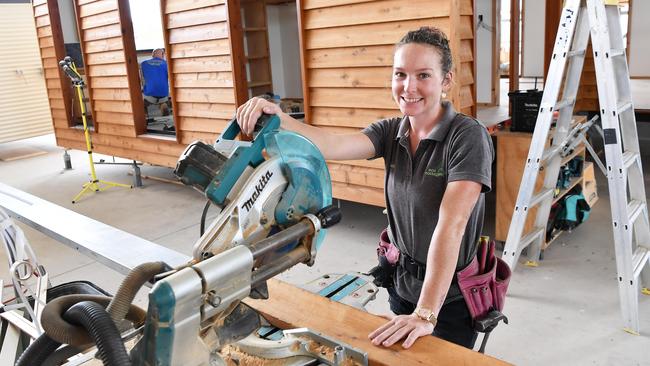 Eco Cottages managing director Greg Phipps said the Cooroy project would help create job opportunities for apprentice carpenters. Pictured is apprentice carpenter Rachel Stewart. Picture: Patrick Woods.