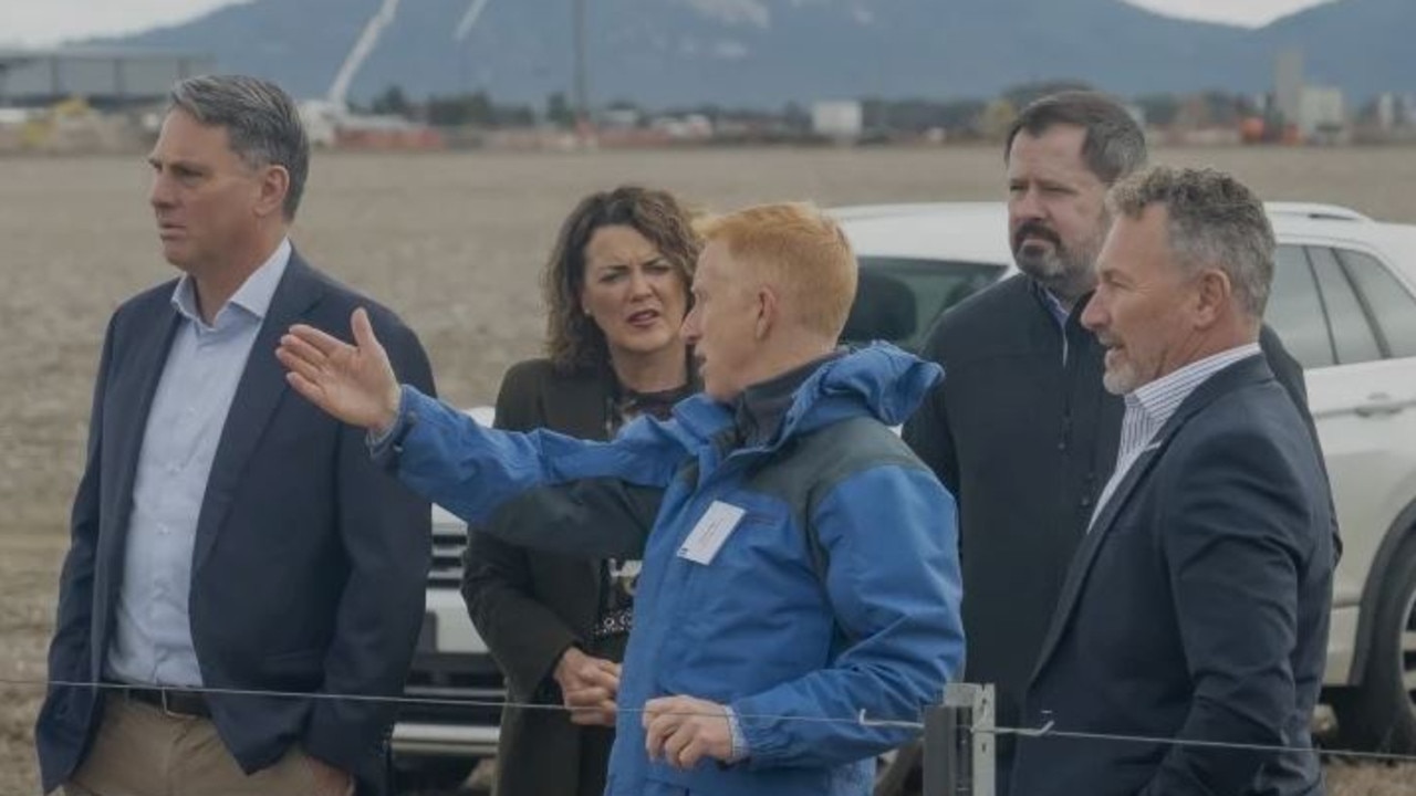 Richard Marles, Libby Coker, Ed Husic (second from right) at the proposed Avalon site of the "gigafactory" at Avalon Airport industrial precinct.