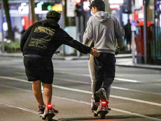 People riding scooters in MelbourneÃ¢â¬â¢s CBD without wearing helmets. Hospitals are reporting high levels of scooter injuries. Picture: Ian Currie