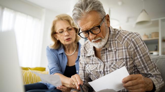 Shot of a senior couple looking stressed while going over their finances at home; wealth superannuation worries generic bills