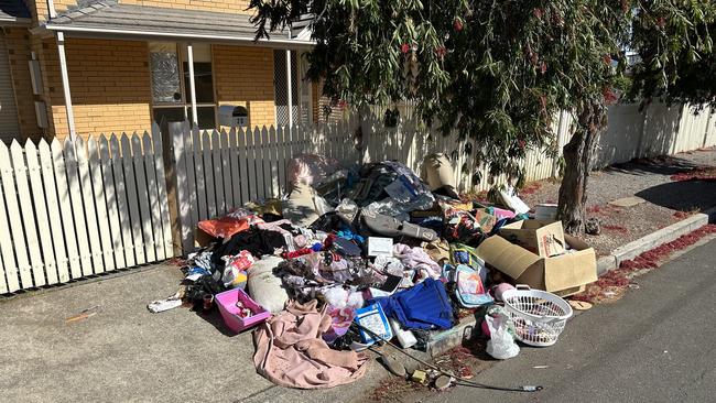 A Campbelltown housing trust home left with piles of rubbish dumped outside. Picture: Supplied