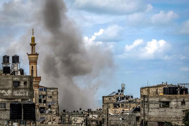 A smoke plume erupts during Israeli bombardment in Rafah, the southern Gaza Strip, where world leaders have warned against an Israeli ground operation