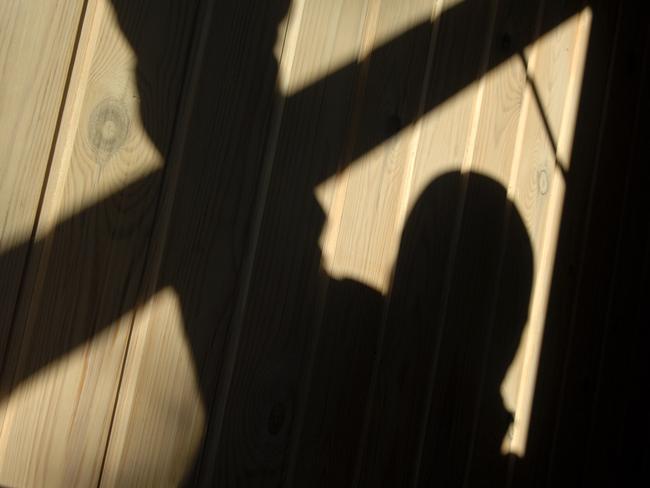 Shadow of a burglar (or murderer or rapist) while he enters through an open window. Picture: Istock