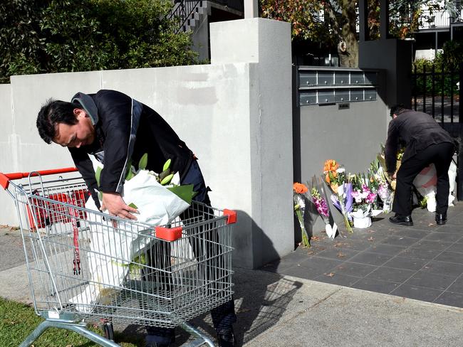 Floral tributes continue to grow outside the apartments. Picture: Nicole Garmston