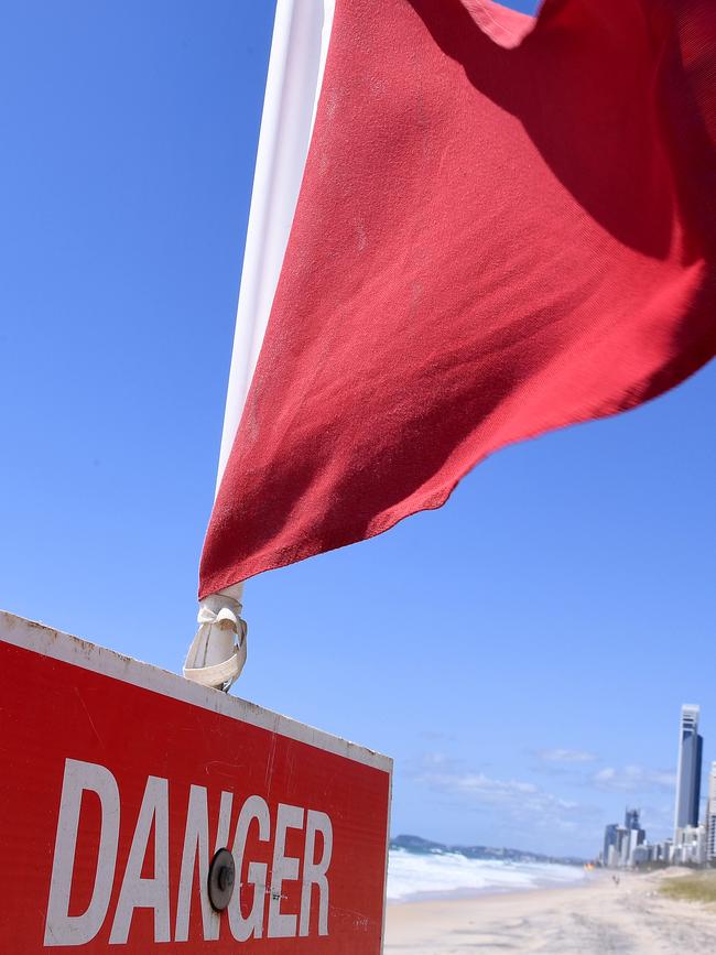Warning flags are seen on the Gold Coast, Wednesday, February 20, 2019. Huge swells and high tides are set to pummel south-east Queensland beaches over the coming days as Cyclone Oma tracks towards the Queensland coast. Photo: Dave Hunt/AAP.
