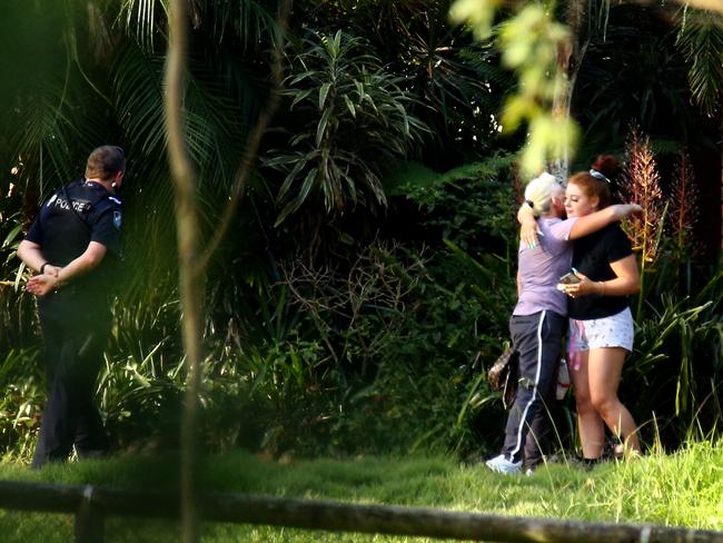 People at the property are seen embracing after the tragedy. Picture David Clark