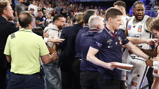 MELBOURNE, AUSTRALIA - NOVEMBER 17: A fight breaks out on the Adelaide 36ers interchange as member of the crowd gets involved with the players on the bench during the round nine NBL match between Melbourne United and Adelaide 36ers at John Cain Arena, on November 17, 2024, in Melbourne, Australia. (Photo by Darrian Traynor/Getty Images)