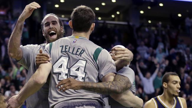 Boston Celtics centre Tyler Zeller (44) celebrates with teammates Luigi Datome, left, and Isaiah Thomas, right, after he hit the game-winning shot in second half of an NBA basketball game against the Utah Jazz.