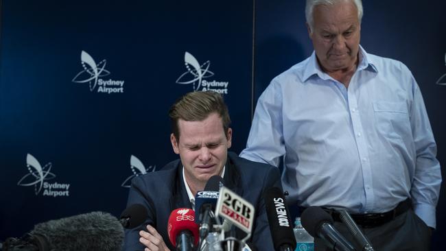 Steve Smith comforted by his father Peter as he confronts the media. (Brook Mitchell/Getty Images)