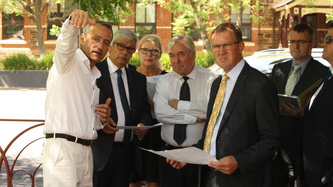 Hula Hoop owners Jon (left) and Steph Hamra (back) show their lawyer Brian Hayes QC, Judge Bill Jennings and On The Run lawyer Stuart Henry SC around the Regal Theatre Garden.