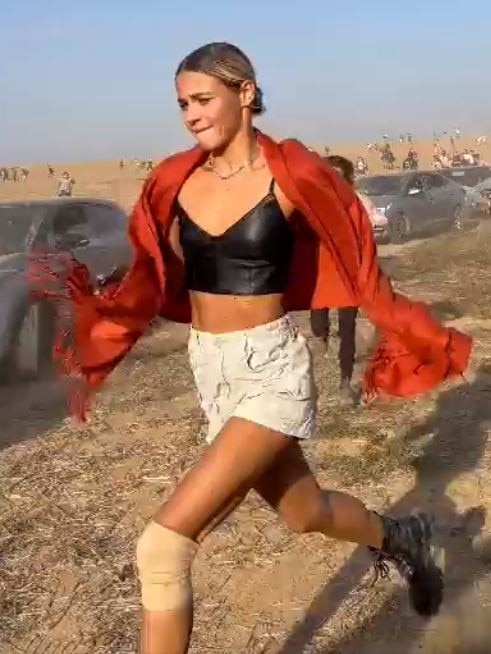 A woman flees the attack on the Supernova music festival at Kibbutz Re’im.