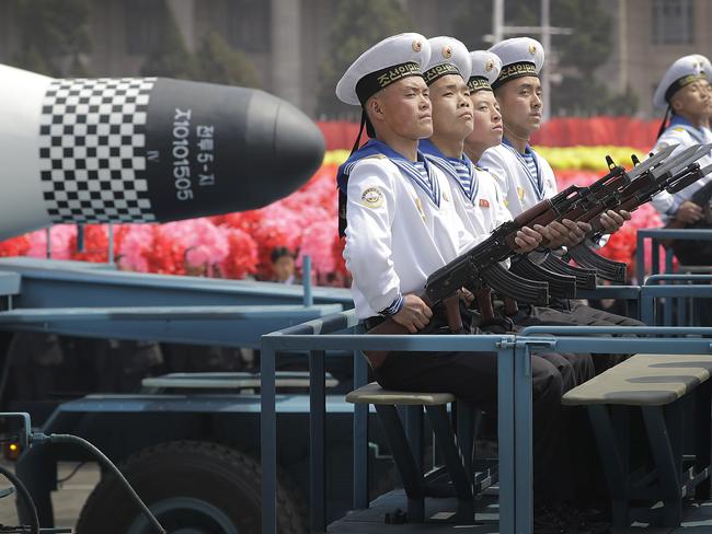 Navy personnel sit in front of a submarine-launched Pukguksong ballistic missile (SLBM) as it is paraded across Kim Il-sung Square in Pyongyang, last April. Picture: Wong Maye-E/AP