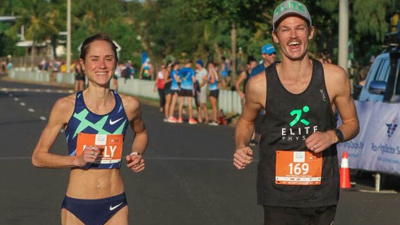 Women’s winner Milly Clark does a victory run with men’s winner Tim Hewitt after Sunday’s 2021 City2Surf race was run and won. Picture: Glenn Campbell